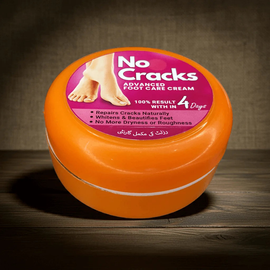 Orange jar of 'No Cracks' foot care cream on a wooden surface with a dark background