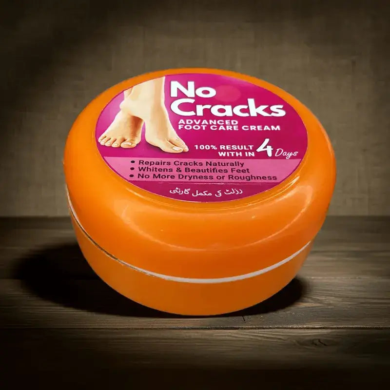 Orange jar of 'No Cracks' foot care cream on a wooden surface with a dark background