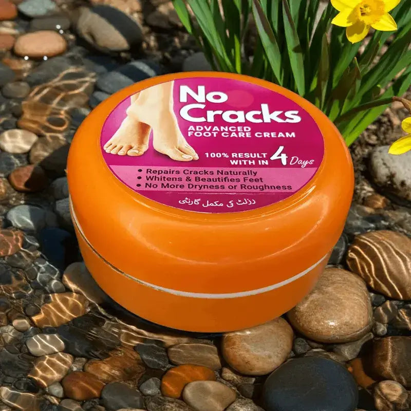 Orange jar of 'No Cracks' foot care cream on a pebble surface with flowers.