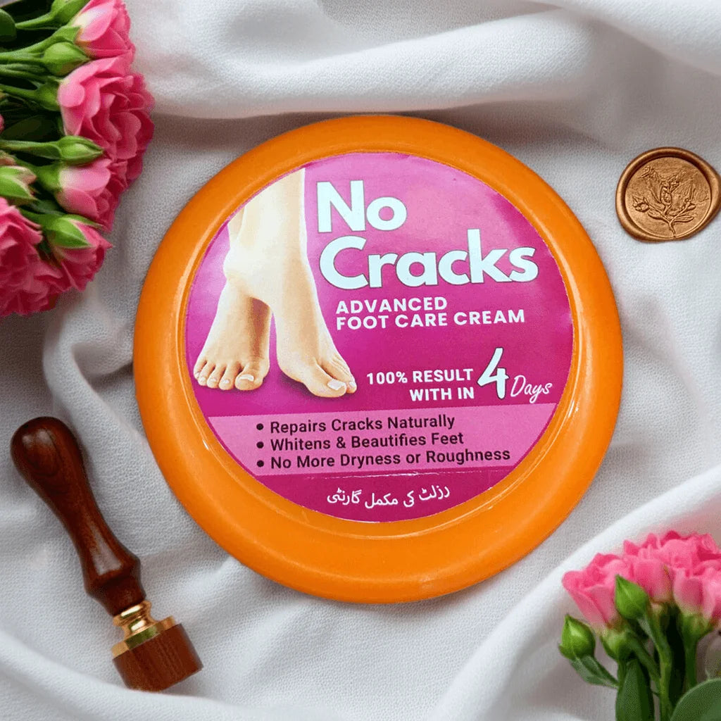 No Cracks foot care cream container with pink label on a white fabric background with flowers.