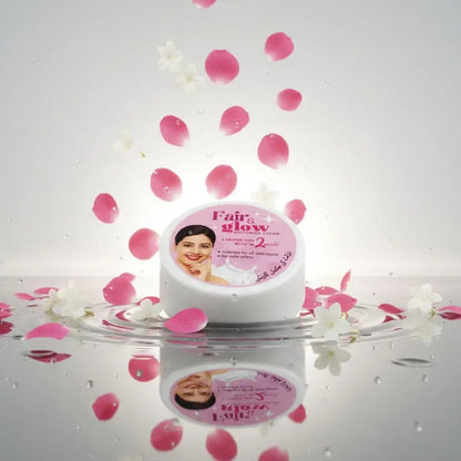 Cosmetic jar labeled 'Fair & Glow' with pink flower petals on a reflective surface