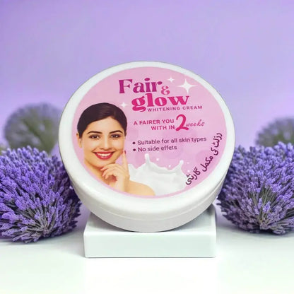 Fair & Glow whitening cream jar with a woman's face on it, surrounded by purple flowers.